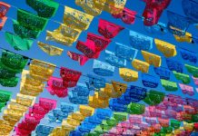 Colorful papel picado hanging in a Mexican town