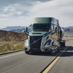 A Volvo truck driving down a highway